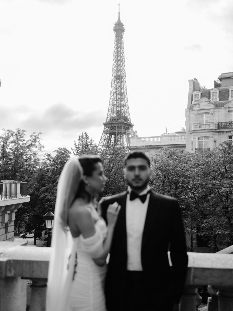 Black and white photography of a married couple in a street with Eiffel Tower view