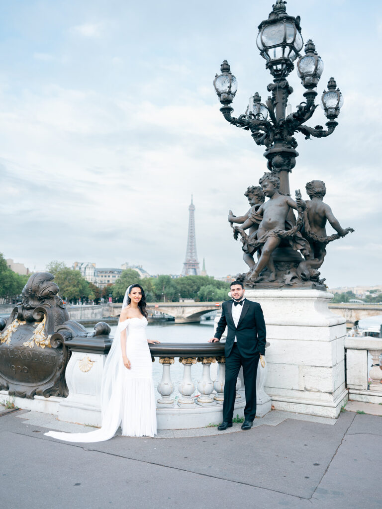 Paris wedding photo of a couple posing on Pont Alexandre III